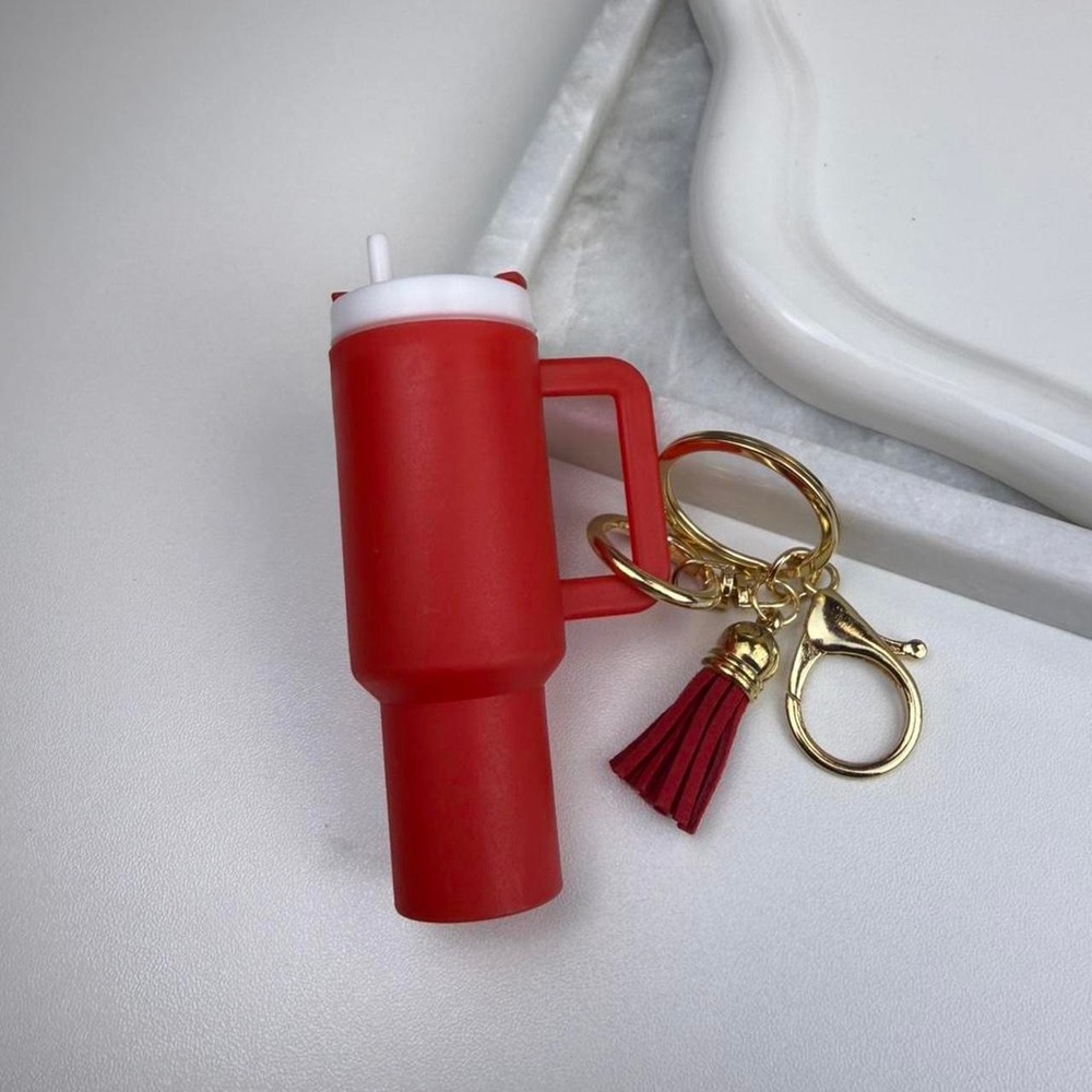 Red tumbler keychain Gold-tone hardware with red tassel + charm detail